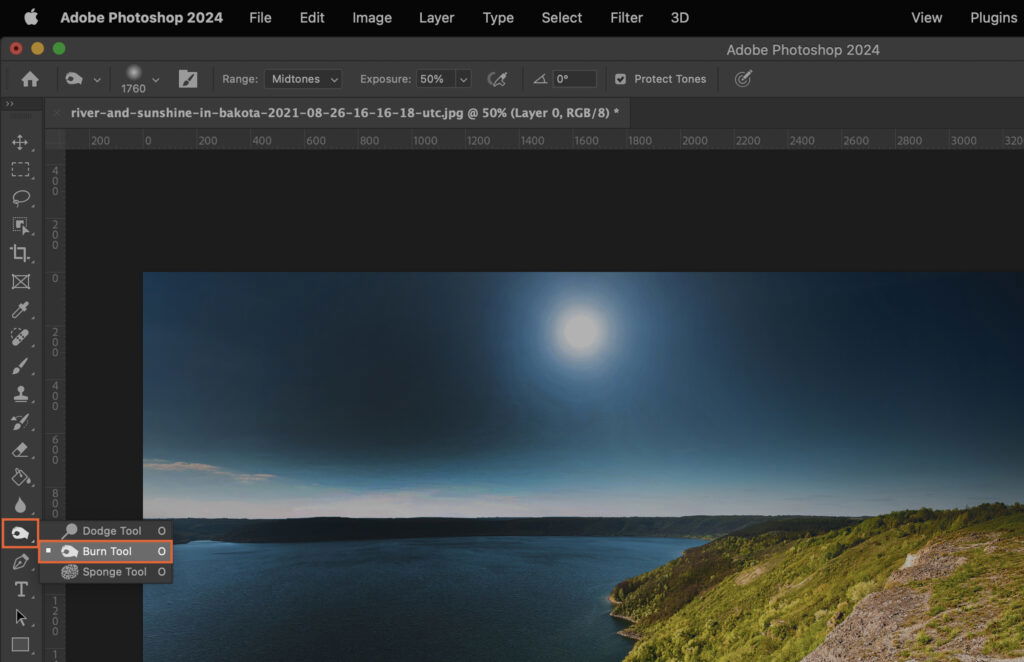 The Adobe Photoshop interface displaying a photo with a sunset, water, and mountains background, showcasing a sunset picture with various interface elements highlighted. 