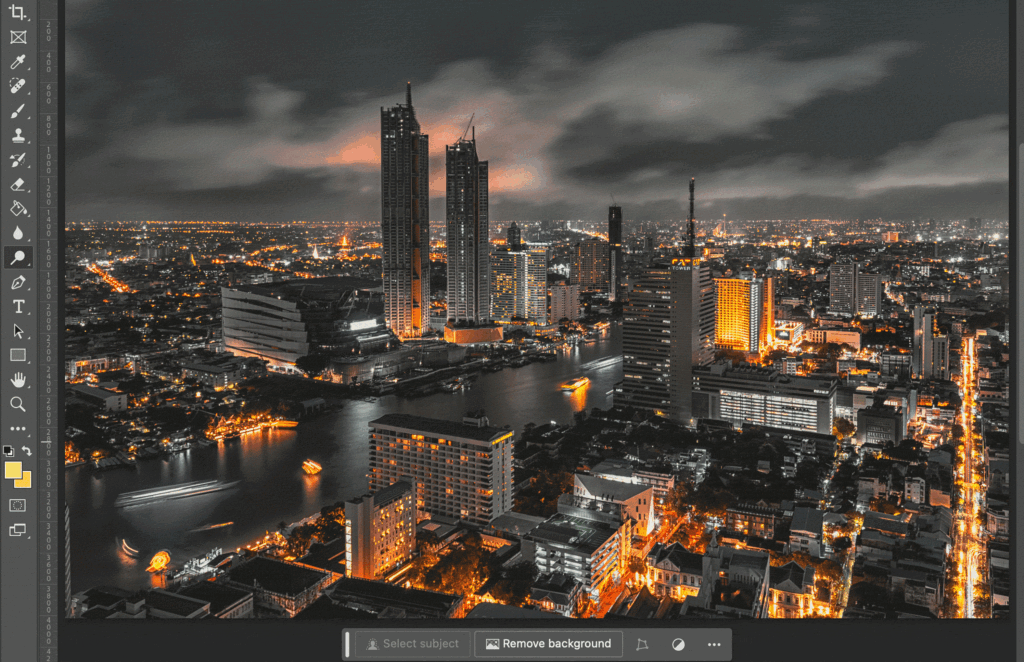 A cityscape at night, with tall buildings illuminated against the dark sky. 