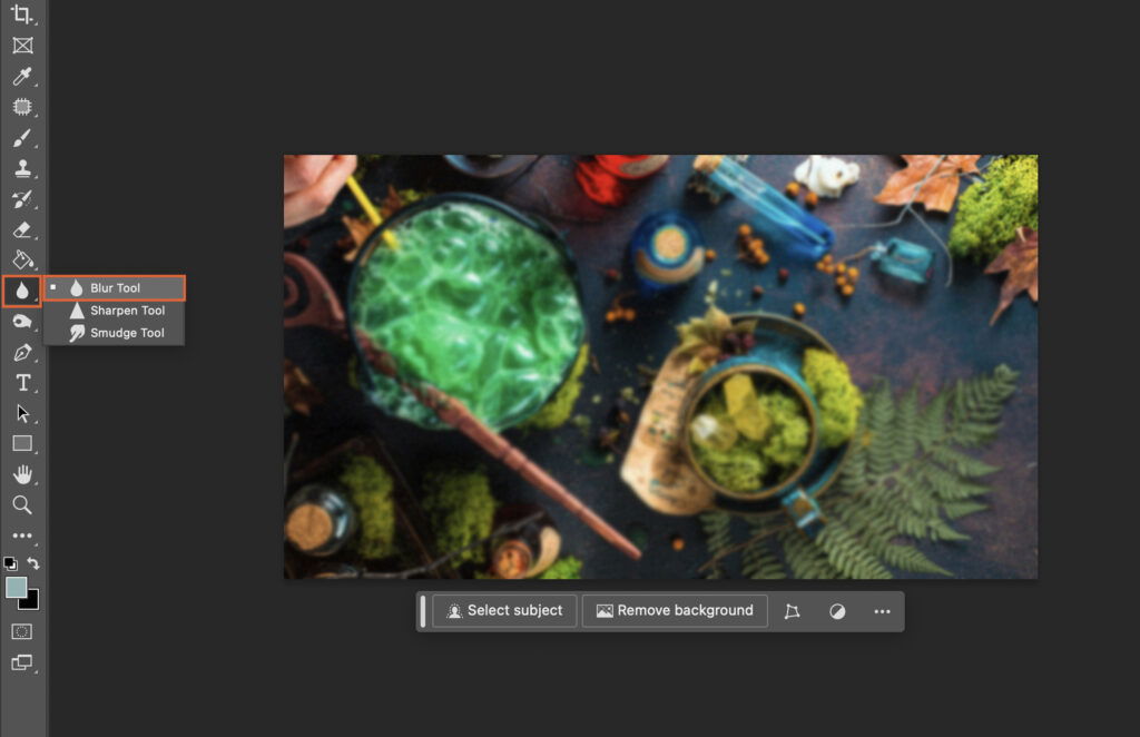 An image editing software interface, featuring a colorful, blurred background with various objects.