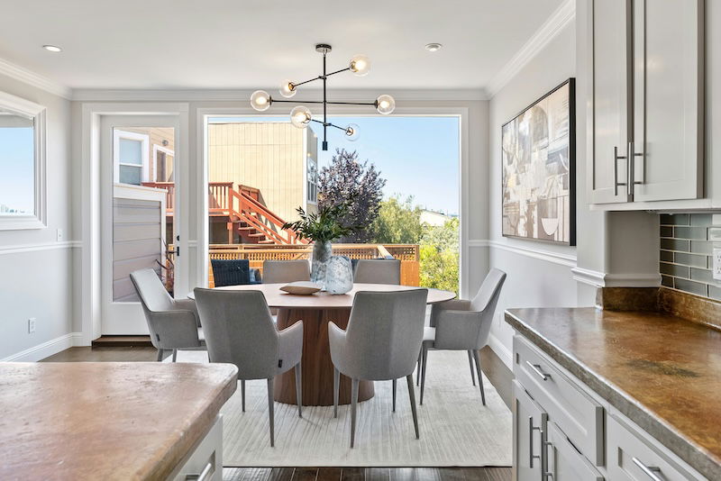 an interior shot of a house showing a modern dinner table and open backdoor with a deep depth of field