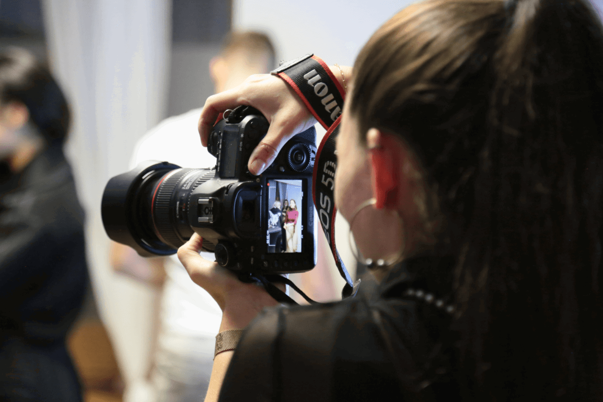 A photographer using the screen on their camera to frame a shot