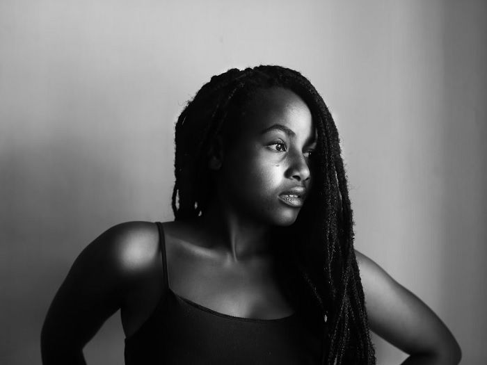 Black and white portrait of young woman with braided hair