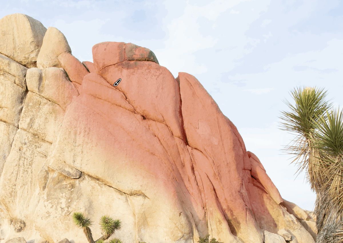 crop of photograph of a rocky mountain with a tree in the foreground showing the mask brush tool with auto mask in action