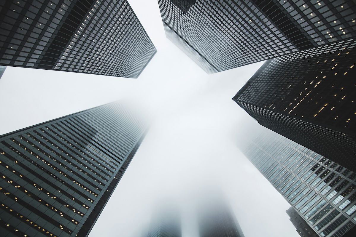 A cityscape photograph with skyscrapers in the background, a checkered crossfade, and a watermark-like design. 