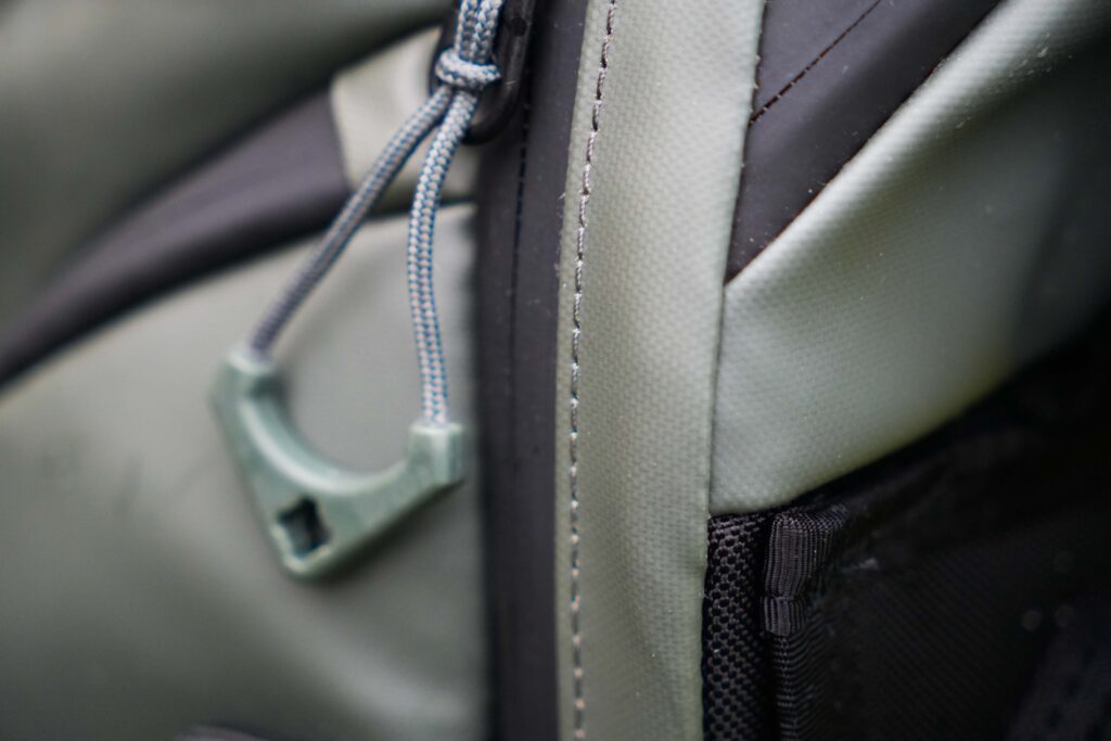 A backpack with a blue zipper, taken up close to show the details of the bag. 