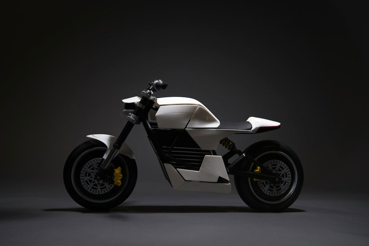 A white and black concept motorcycle is displayed against a dark background.