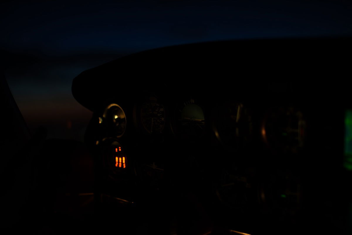 underexposed image of a cockpit at night