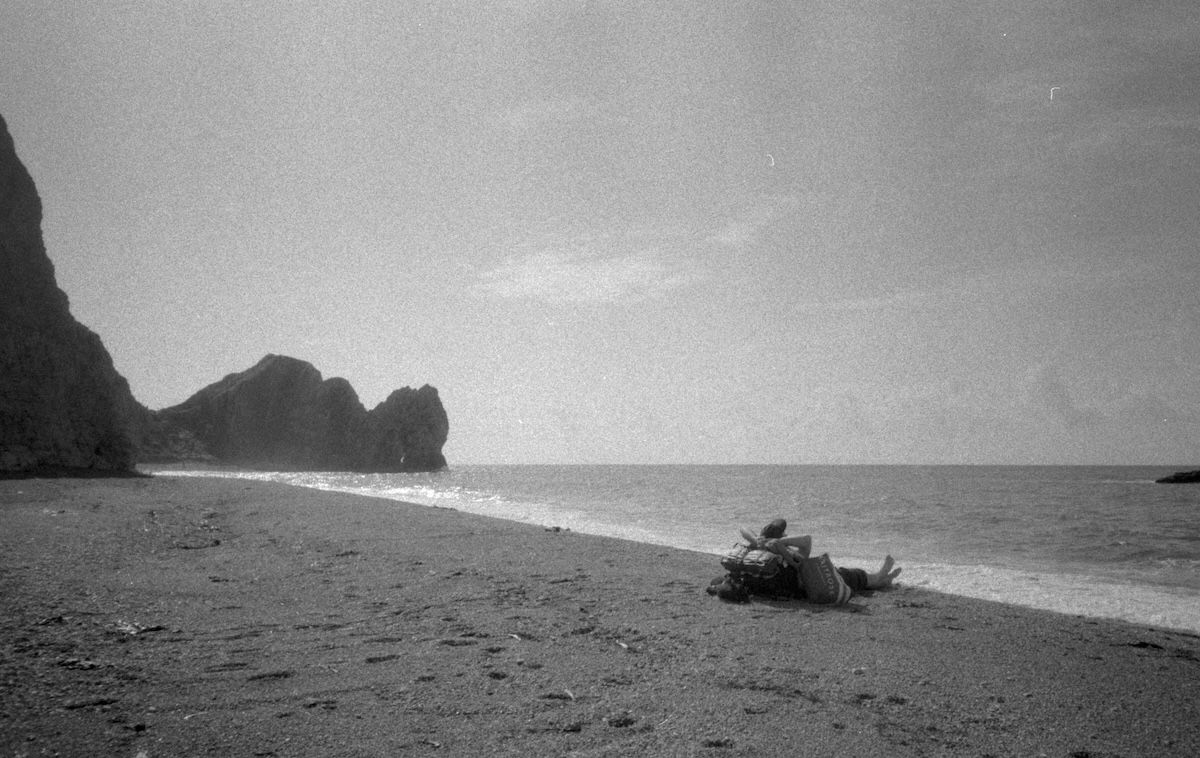 grainy 35mm film photo of a beach