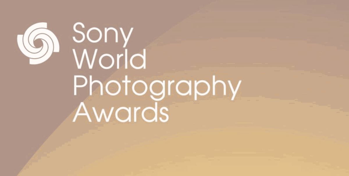 A promotional poster for the Sony World Photography Awards, which features a warm orange and gold color scheme. 