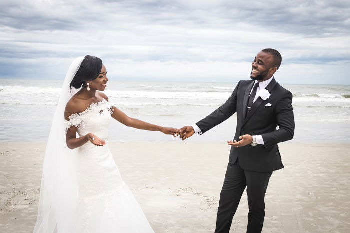 Bride and groom holding hand on a beach