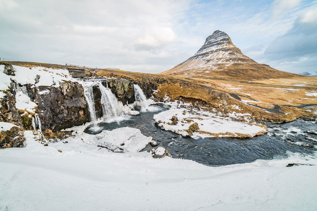 photo of a mountain and waterfall in foreground