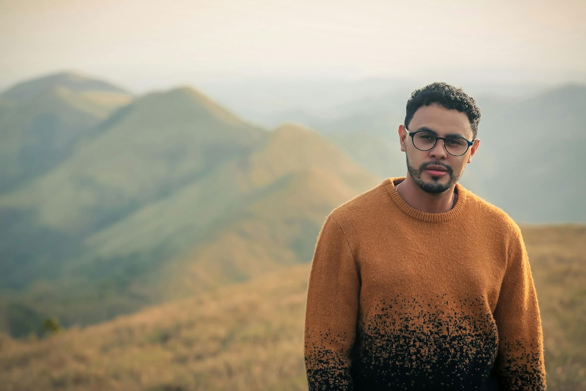 portrait of man on a mountain range