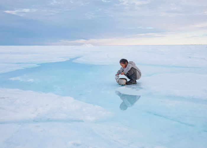 Inuit girl collecting water