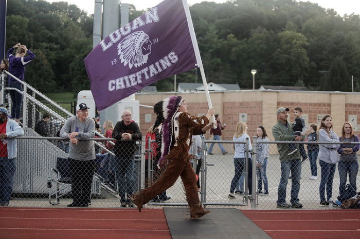 Native American sports mascot running with flag