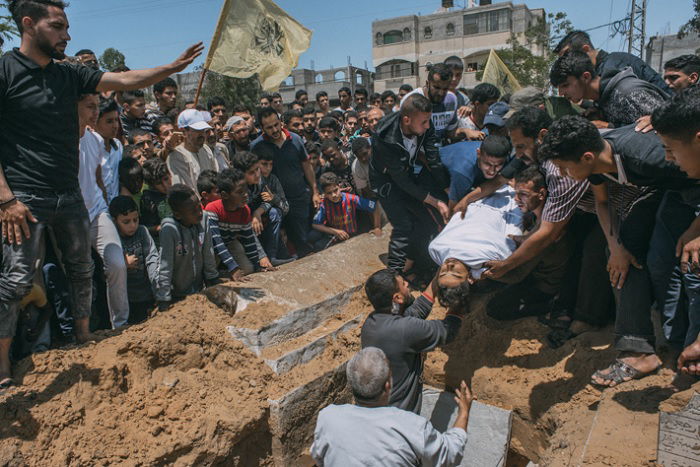 Man being buried with many onlookers