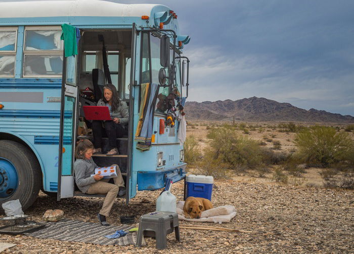 Family sitting in and around a bus