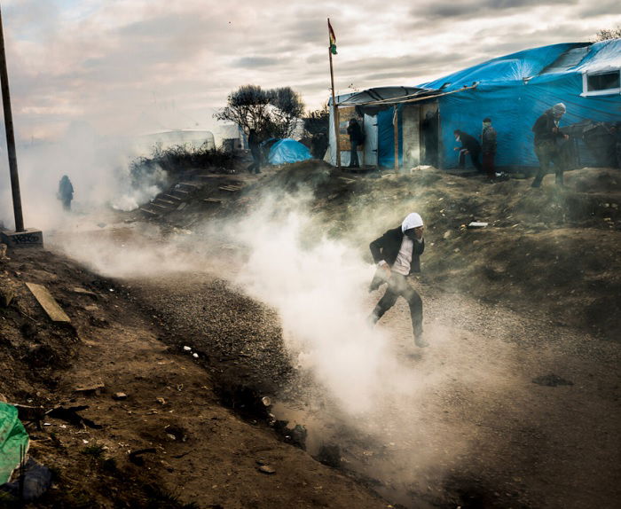 Man running through smokey shanty town street