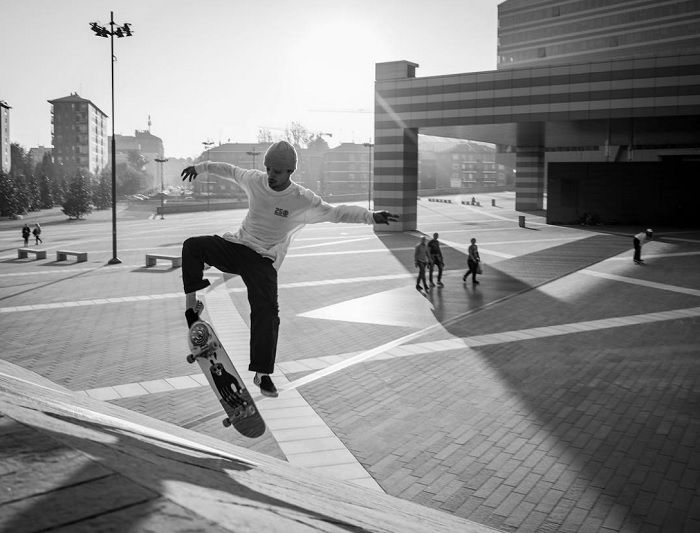 Street skateboarder doing a trick in the evening light