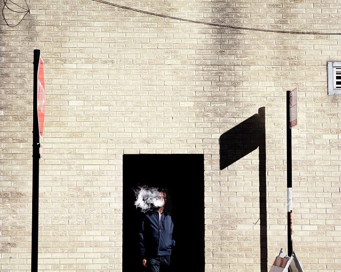 Man smoking in doorway