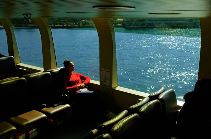 Woman sleeping in the window seat on a ferry