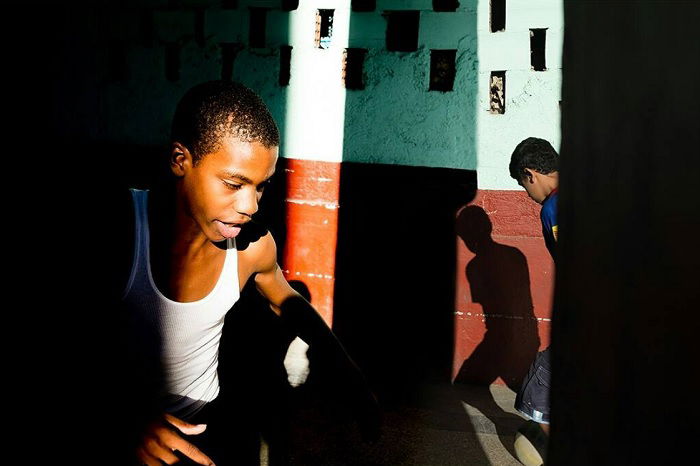 Two young boys playing in a narrow street