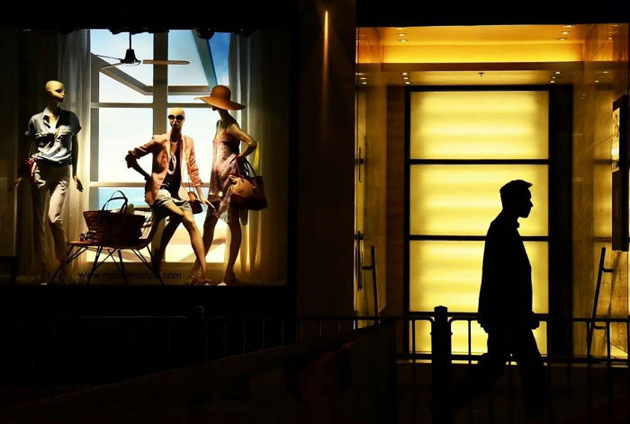 Store window and man walking past