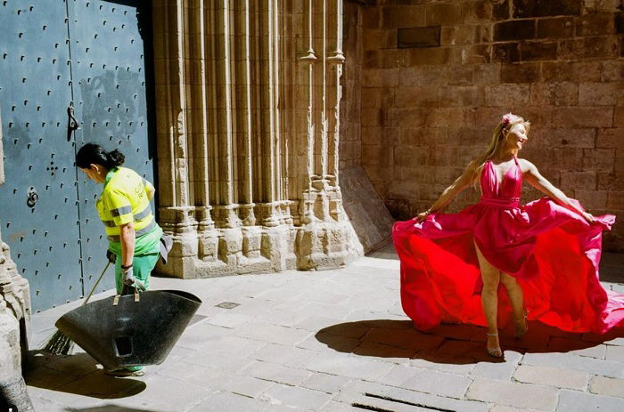 Street cleaner and dancer in red dress in the street