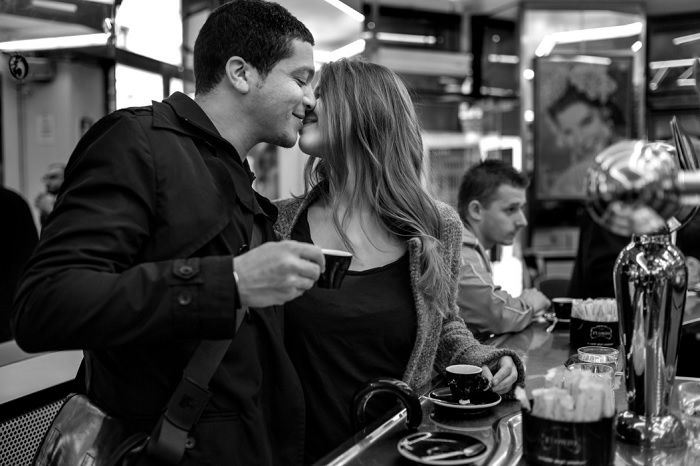 Couple kissing in a Paris cafe