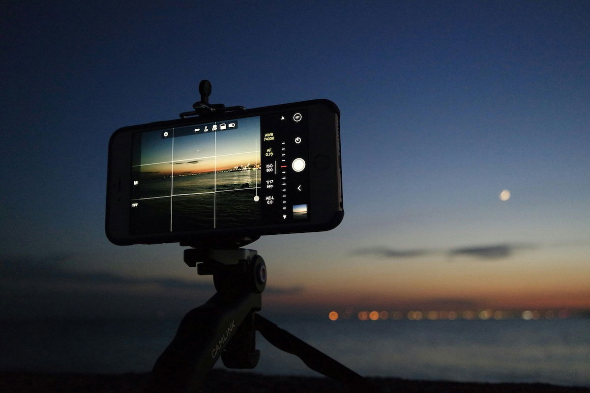 photo of an iphone taking an image at sunset