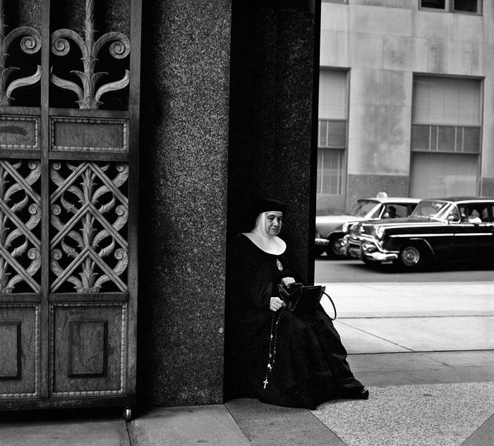 Nun sitting on a street corner