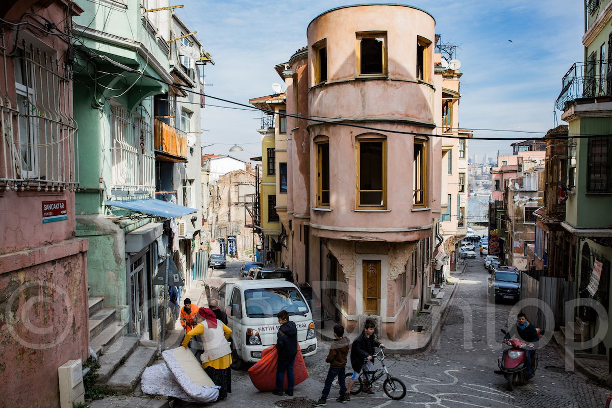 photo of a street with boys playing with watermark