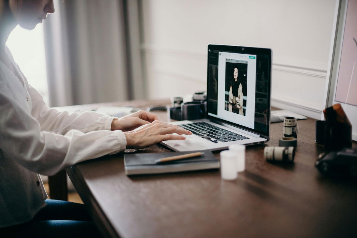 person sitting at desk photo editing