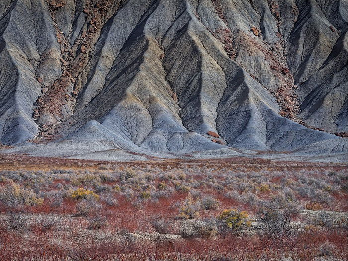 Desert in from of big rock formation