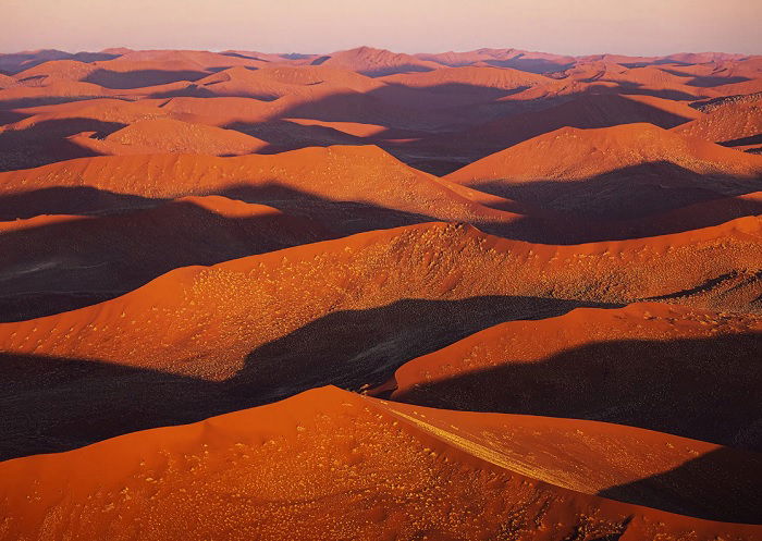 Landscape of desert dunes near sunset