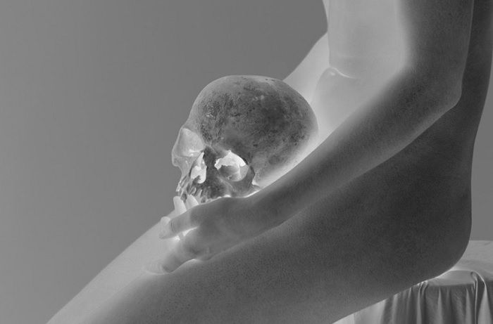 Infrared image of woman holding skull in crotch