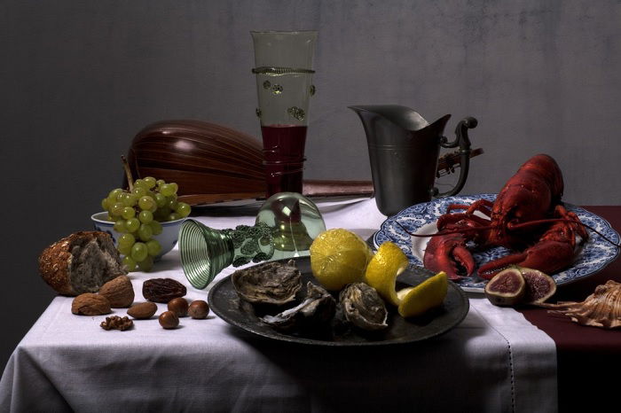 Still life of foods and drinks on a dressed table