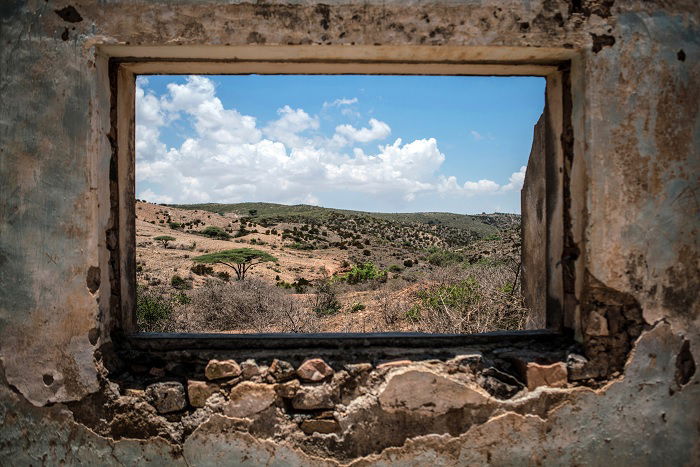 Desert seen through a widow frame of old house