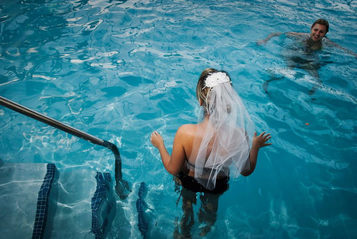 Woman in wedding vale in a swimming pool