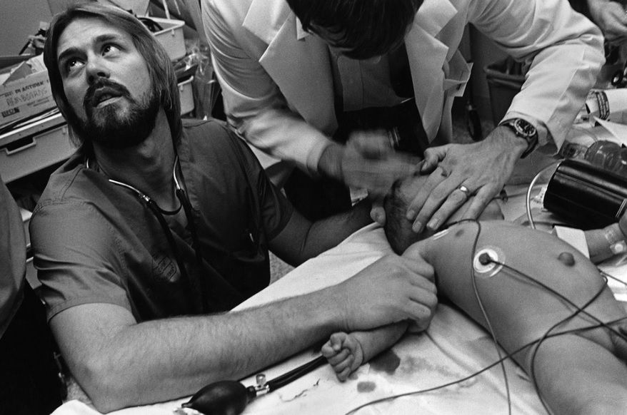 Nurse and doctor attending to sick baby