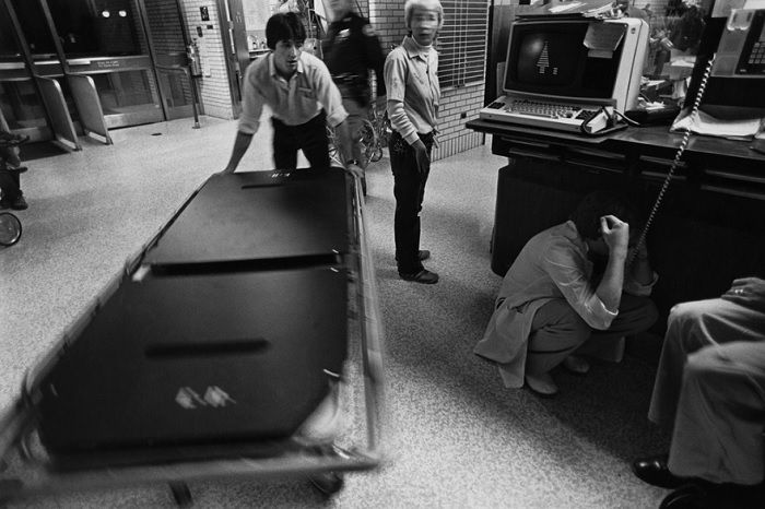 hospital orderly moving hospital bed in waiting room