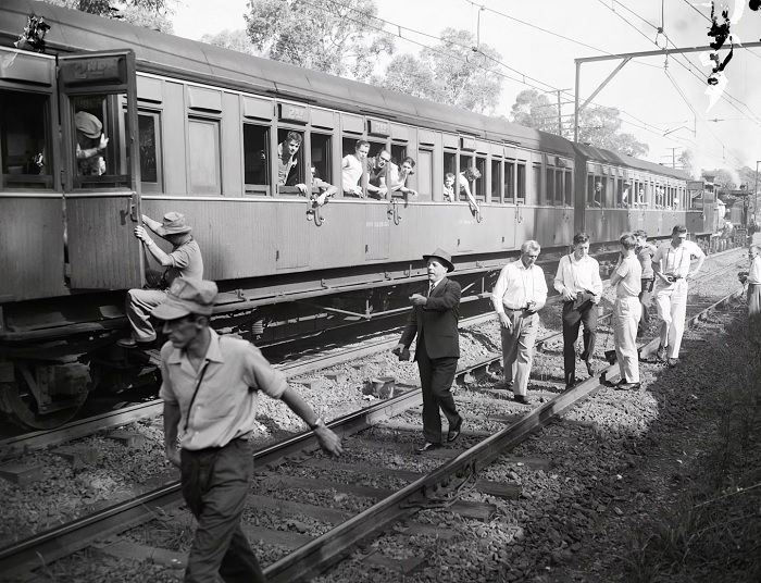 Old train with people getting on and off