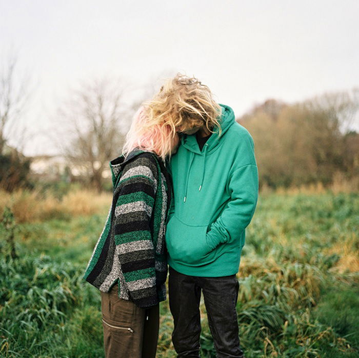 Two women embracing in a field