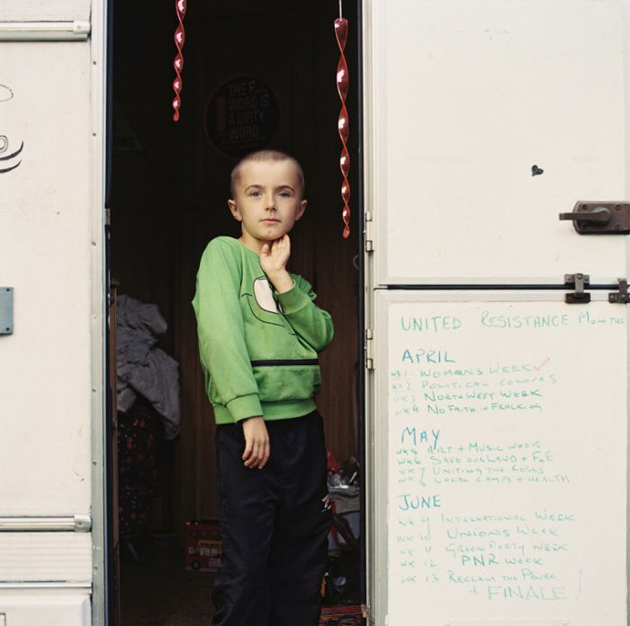 Young boy standing in the doorway of a caravan