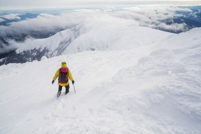 Man working on icy mountain top