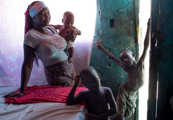 Woman and three kids in darkened room