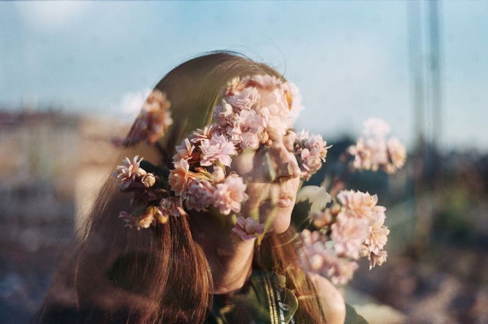 Double exposure of woman and flowers