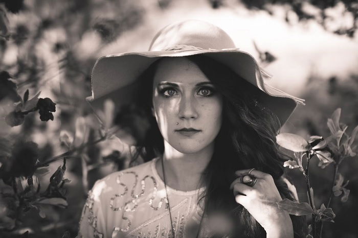 Portrait of young woman in a summer hat